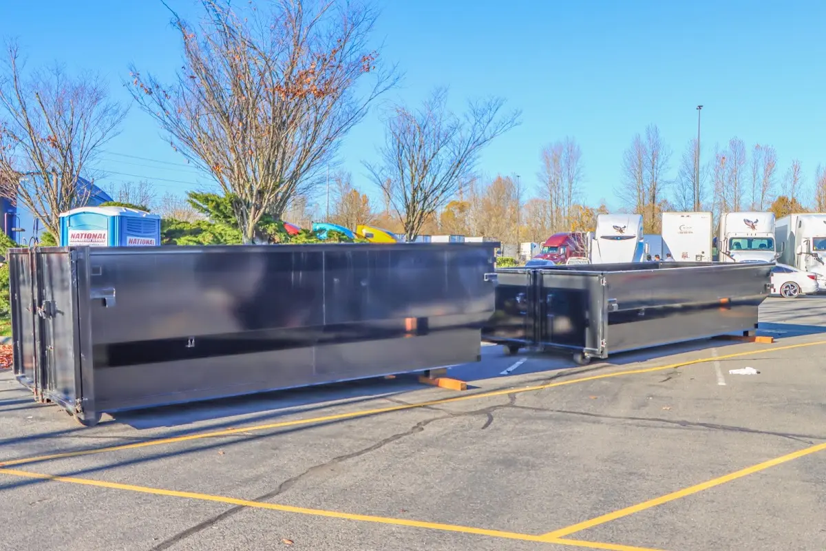 Professional dumpster rental service with roll-off container on residential driveway in Willis